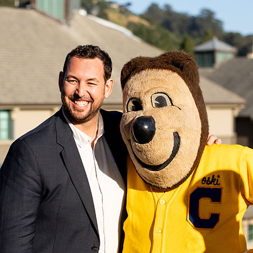 A man with Oski, the UC Berkeley mascot