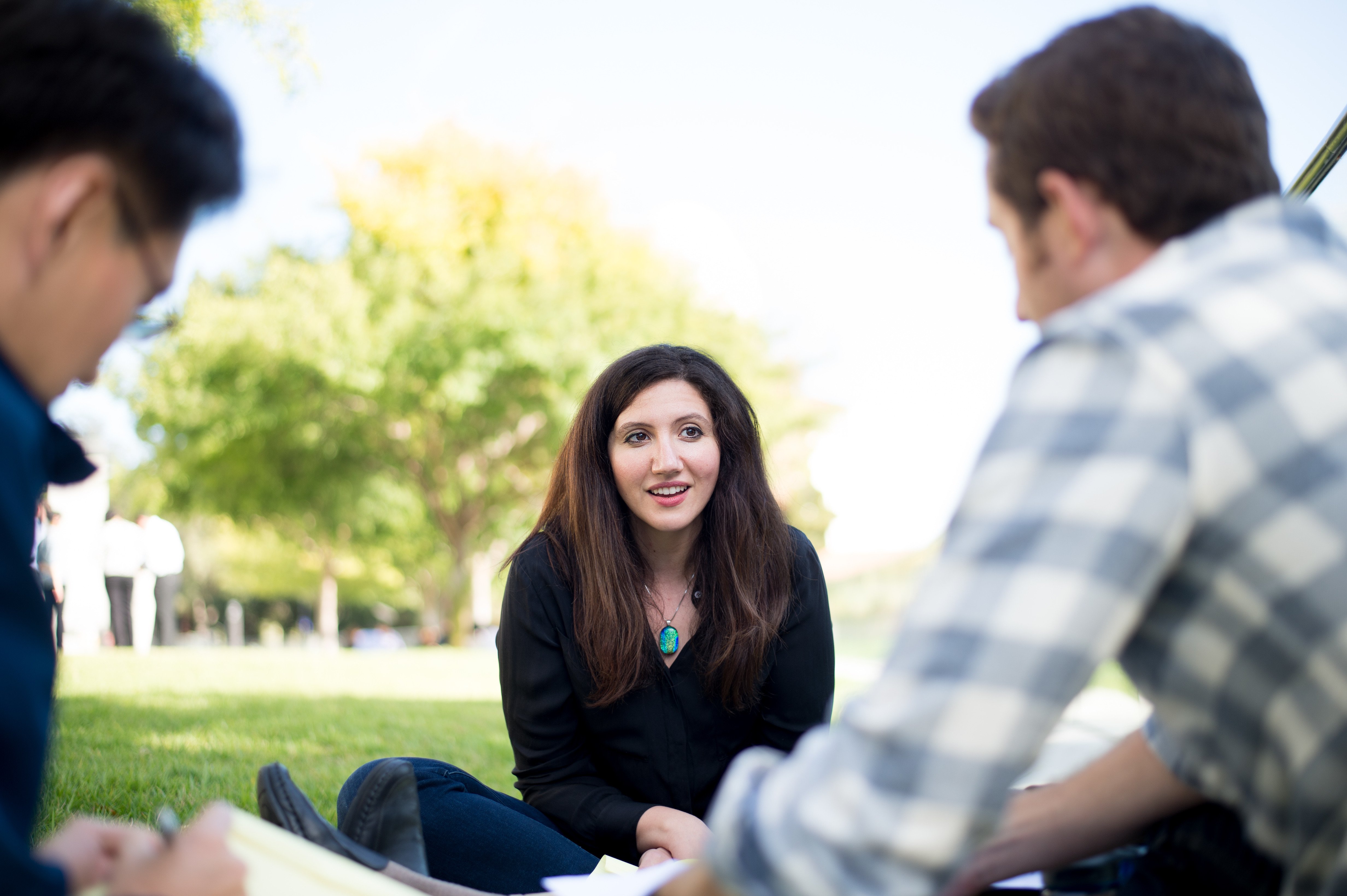 Students work together while relaxing on campus