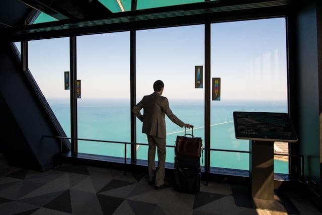 A man standing in front of an airport window