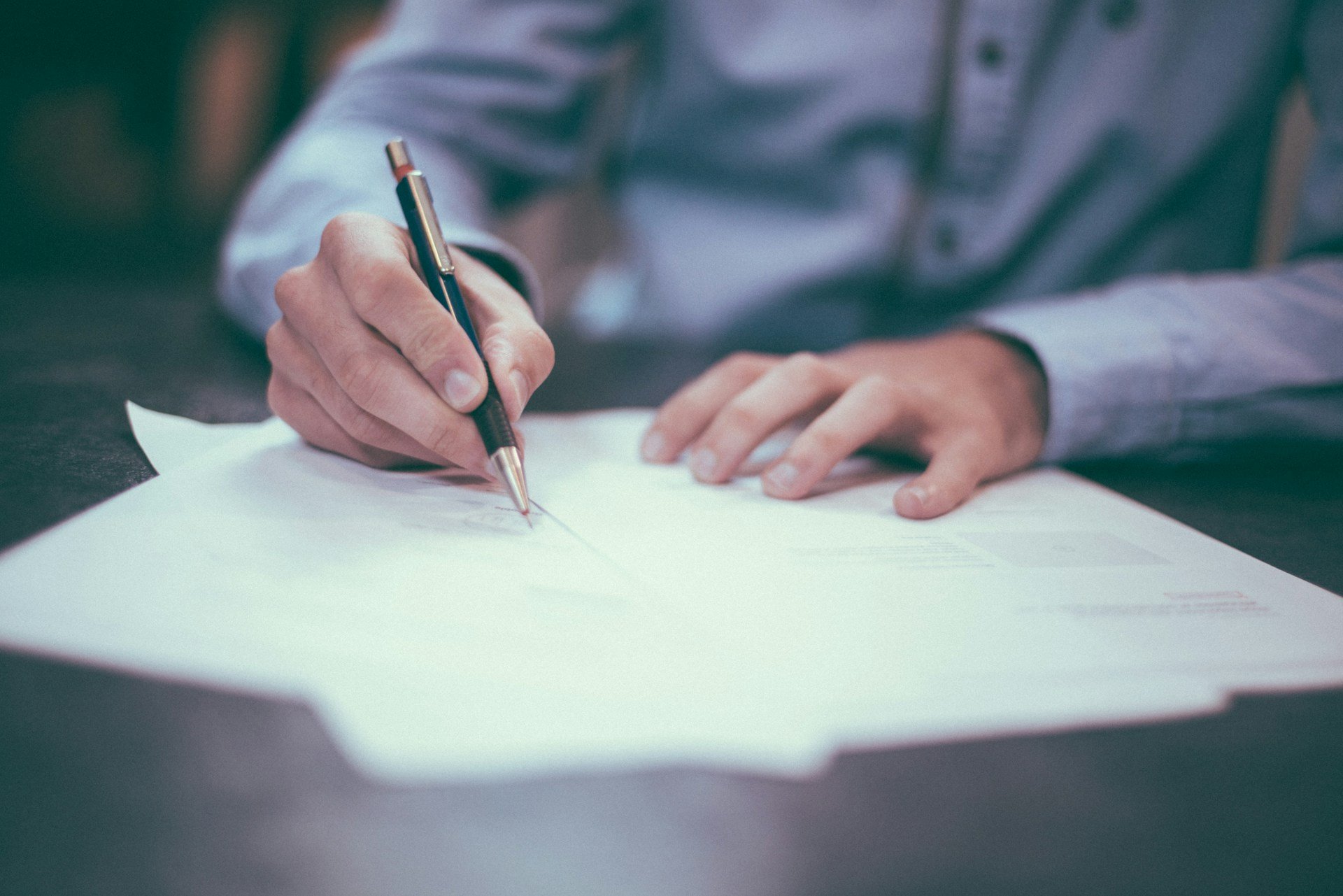 A man writing on paper